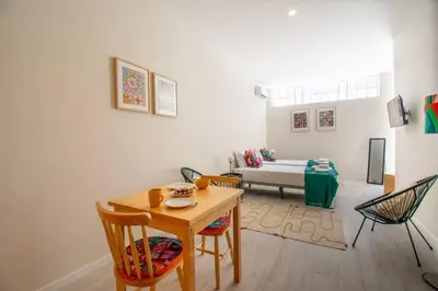 a living room with a table and chairs and a couch at Leote House - Studio 3 in Porto