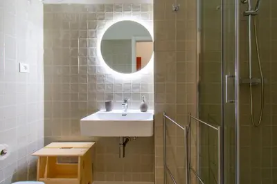 a bathroom with a sink and a shower with a mirror at Leote House - Studio 3 in Porto
