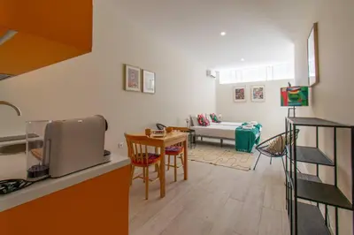 a kitchen and a living room with a couch at Leote House - Studio 3 in Porto