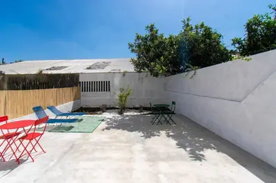 a patio with chairs and tables and a wall at Leote House - Studio 3 in Porto