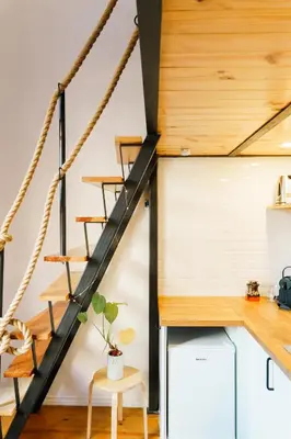 a room with a staircase and a table and stool at The Loft 333 in Porto