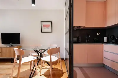 a kitchen with a glass table and chairs at Rivoli Apartments in Porto