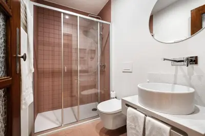 a bathroom with a shower and a sink and a toilet at Rivoli Apartments in Porto