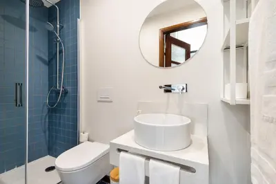 a bathroom with a sink and a toilet and a mirror at Rivoli Apartments in Porto