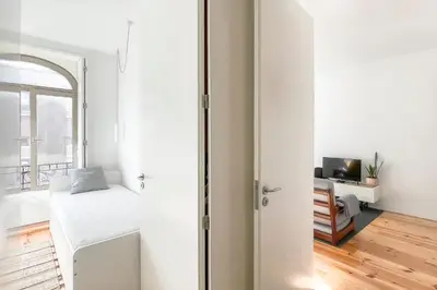a white bathroom with a shower and a sink at Boavista 2-Bedroom Apartment in Porto