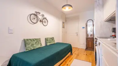 a bedroom with a bed and a bike on the wall at Taipas Tranquility: Cozy T0 by LovelyStay in Porto