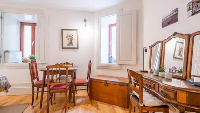 a dining room with a table and a mirror at Taipas Tranquility: Cozy T0 by LovelyStay in Porto