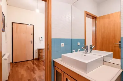 a bathroom with a white sink and a mirror at VIVA Old Franciscan Studio in Porto