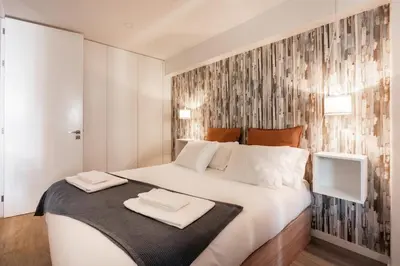 a bedroom with a bed with two towels on it at Patio in Central Porto in Porto