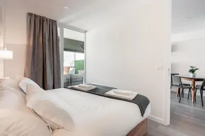 a bedroom with a bed with two towels on it at Patio in Central Porto in Porto