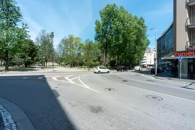 a white car is driving down a city street at Patio in Central Porto in Porto