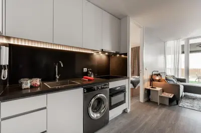 a kitchen with a sink and a washing machine at Patio in Central Porto in Porto