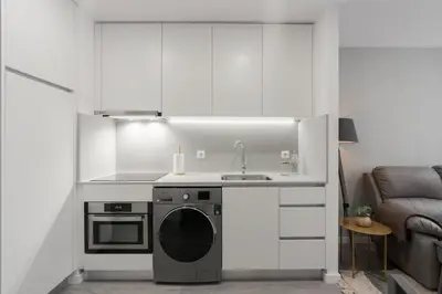 a kitchen with a sink and a washing machine at Great Location very Central Boavista in Porto
