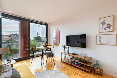 a living room with a tv and a table at Fontainhas Royal in Porto