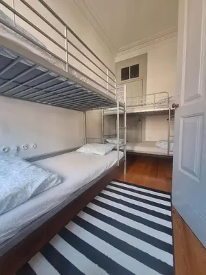 a bedroom with two bunk beds and a rug at Easy Host Porto in Porto