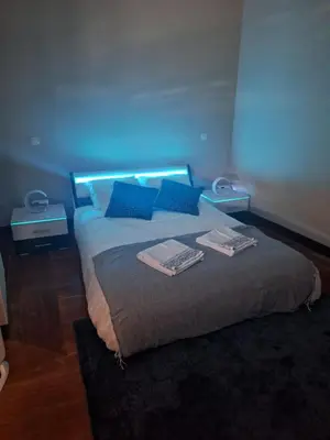 a bedroom with a bed with blue lights on it at Easy Host Porto in Porto