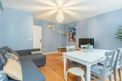 a living room with a couch and a table at GuestReady - Miragaia Blue in Porto