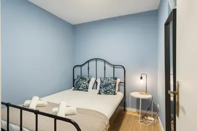 a bedroom with a bed with blue walls at GuestReady - Miragaia Blue in Porto
