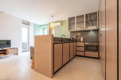 a kitchen with wooden cabinets and a sink at The Priest's Home by LovelyStay in Porto