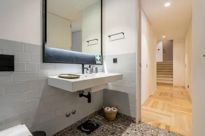 a bathroom with a sink and a mirror at The Priest's Home by LovelyStay in Porto