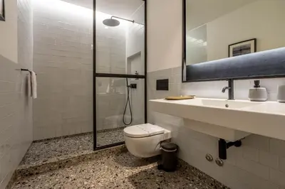a bathroom with a toilet and a sink and a shower at The Priest's Home by LovelyStay in Porto
