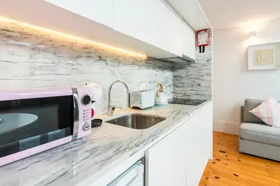 a kitchen with a sink and a microwave at GuestReady - Stylish Haven near Porto Cathedral in Porto