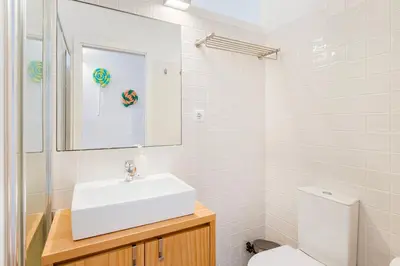 a white bathroom with a sink and a toilet at GuestReady - Stylish Haven near Porto Cathedral in Porto