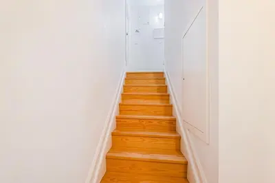 a stairway with white walls and wooden floors at GuestReady - Stylish Haven near Porto Cathedral in Porto