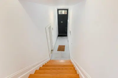 a hallway with white walls and a black door at GuestReady - Stylish Haven near Porto Cathedral in Porto
