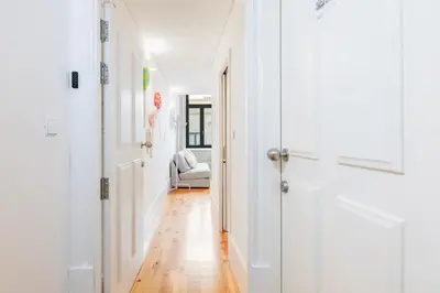 a hallway with a white door and a chair in a room at GuestReady - Stylish Haven near Porto Cathedral in Porto