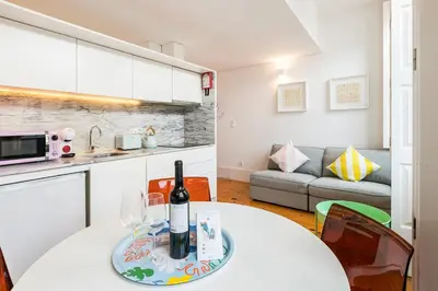 a room with a table with a bottle of wine on it at GuestReady - Stylish Haven near Porto Cathedral in Porto