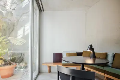 a room with a table and chairs and a window at L'Olivier 23 - 2 apartments in a recently renovated Guesthouse in Porto