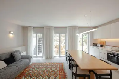 a kitchen and living room with a couch and a table at L'Olivier 23 - 2 apartments in a recently renovated Guesthouse in Porto