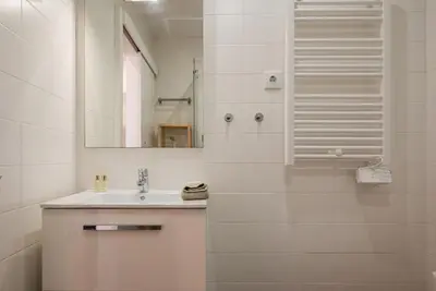 a white bathroom with a sink and a mirror at Gardeny Porto in Porto