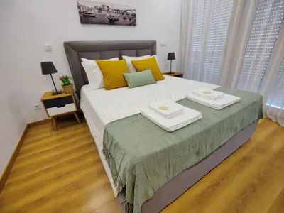 a bedroom with a large bed with two dishes on it at Apartment in the historic center of Porto in Porto