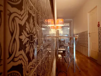 a black triangle stand in a room with a bed at Casa da Maria Reguila in Porto