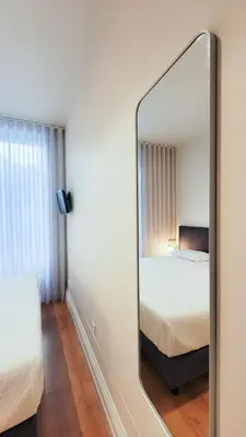 a bedroom with a large bed with a pink blanket at Casa da Maria Reguila in Porto