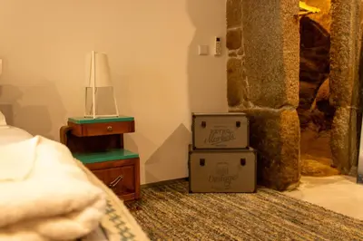 two boxes in a bedroom with a bed and a lamp at ORM Santana Apartment in Porto