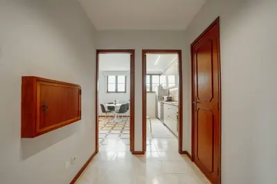 a room with a door and a kitchen with a table at Bonfim Vintage by Hosty in Porto