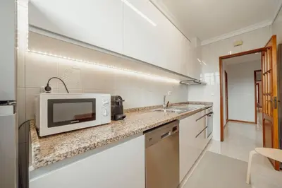 a kitchen with a microwave and a sink at Bonfim Vintage by Hosty in Porto