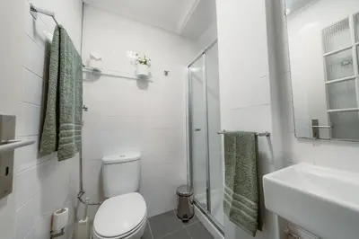 a white bathroom with a toilet and a sink at Douro Garden - Authentic Portuguese Guesthouse in Vila Nova de Gaia