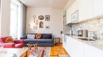 a dining room with a wooden table and chairs at Bolhão Charming Apartment by LovelyStay in Porto