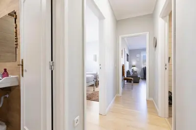 a hallway leading to a bedroom with white walls at MyRiverPlace N 1 River View Porto apartments in Vila Nova de Gaia