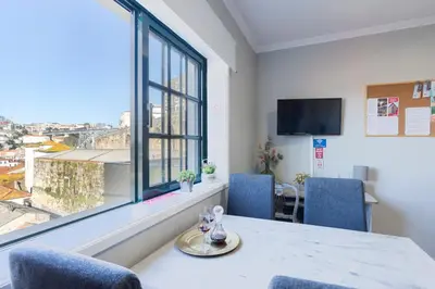 a room with a table and chairs and a window at MyRiverPlace N 1 River View Porto apartments in Vila Nova de Gaia