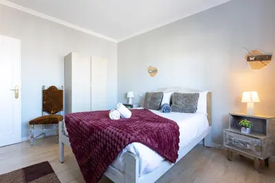 a bedroom with a bed with a red blanket at MyRiverPlace N 1 River View Porto apartments in Vila Nova de Gaia