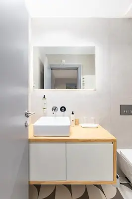 a bathroom with a sink and a mirror at Almada 505 - Premium Flat in Porto