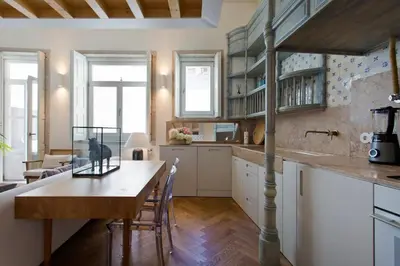 a kitchen with a table with a bird cage on it at BOUTiQUE Rentals- LOvPORTO Ribeira historic center in Porto