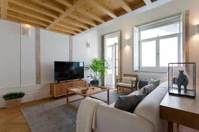 a living room with a couch and a tv at BOUTiQUE Rentals- LOvPORTO Ribeira historic center in Porto