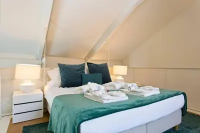 a bedroom with a bed with towels on it at BOUTiQUE Rentals- LOvPORTO Ribeira historic center in Porto