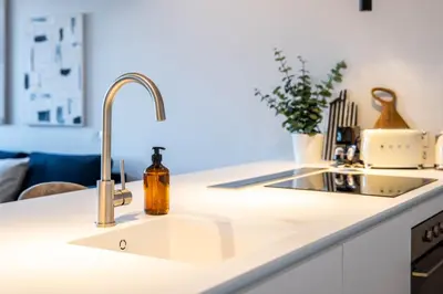a kitchen sink with a bottle of soap on it at Penthouse with City Views - Almada 551 in Porto